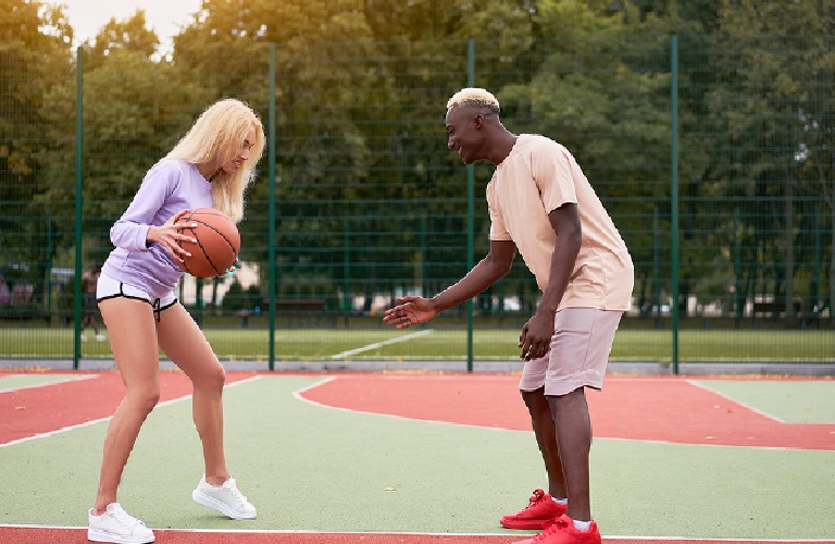 Couple playing basketball