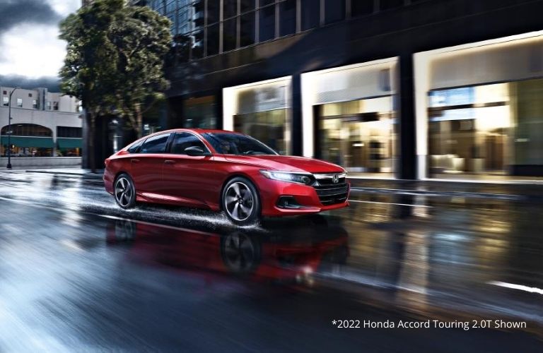 A bright red 2022 Honda Accord Touring 2.0T brightening up the roads at night