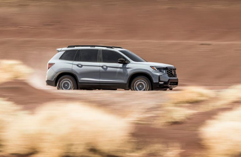 One grey color 2023 Honda Passport is running on the road.