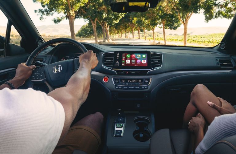Point of view of a couple driving a 2023 Honda Passport is shown.